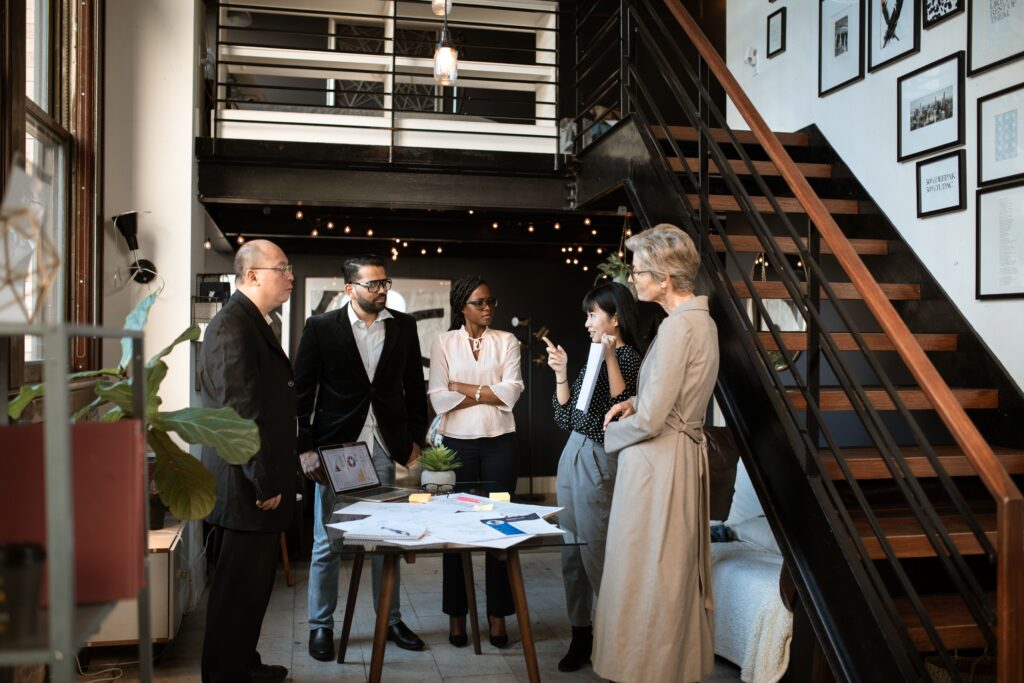 pexels photo 5922079 5922079 Diverse professionals engaged in a meeting in a stylish modern office setting.