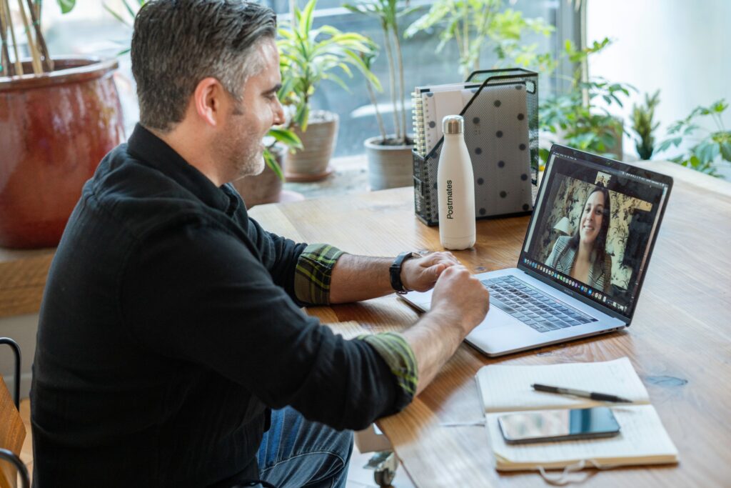 pexels photo 7245797 7245797 A man participates in a virtual meeting from his home workspace, focusing on remote work.