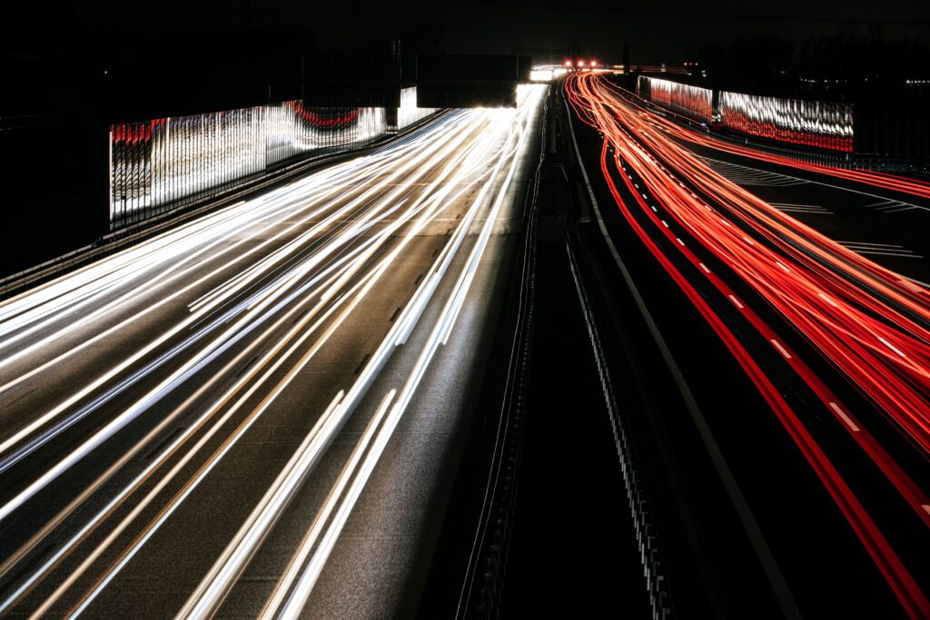 How to Achieve Your Small Business Goals Faster Captivating long exposure of highway light trails at night, showcasing speed and motion.