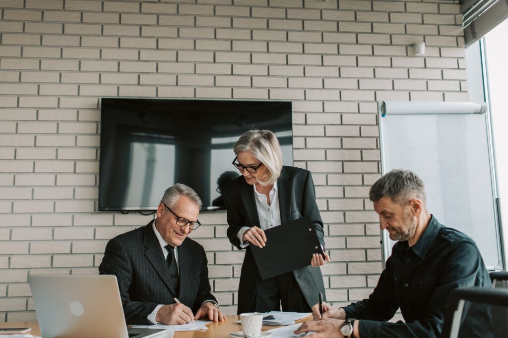 Learn How to Sell With Purpose and Authenticity Business professionals collaborating in a modern office setting with a focus on teamwork and communication.